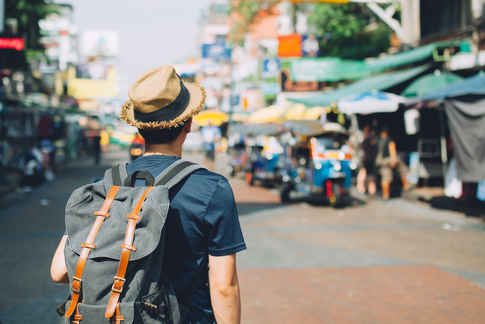Young,Asian,Traveling,Backpacker,In,Khaosan,Road,Outdoor,Market,In